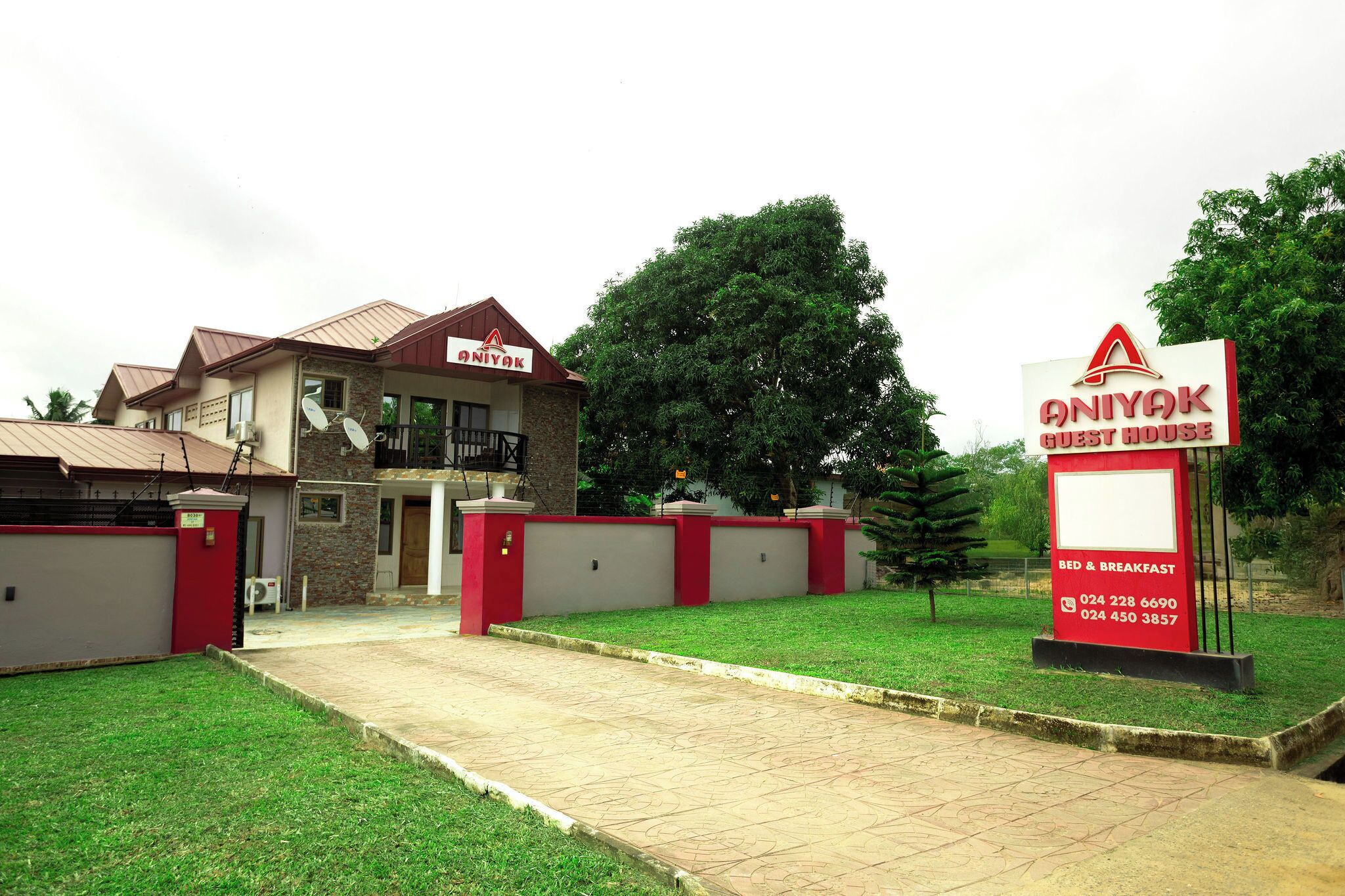 A guest house with a signboard indicating it offers bed and breakfast services.