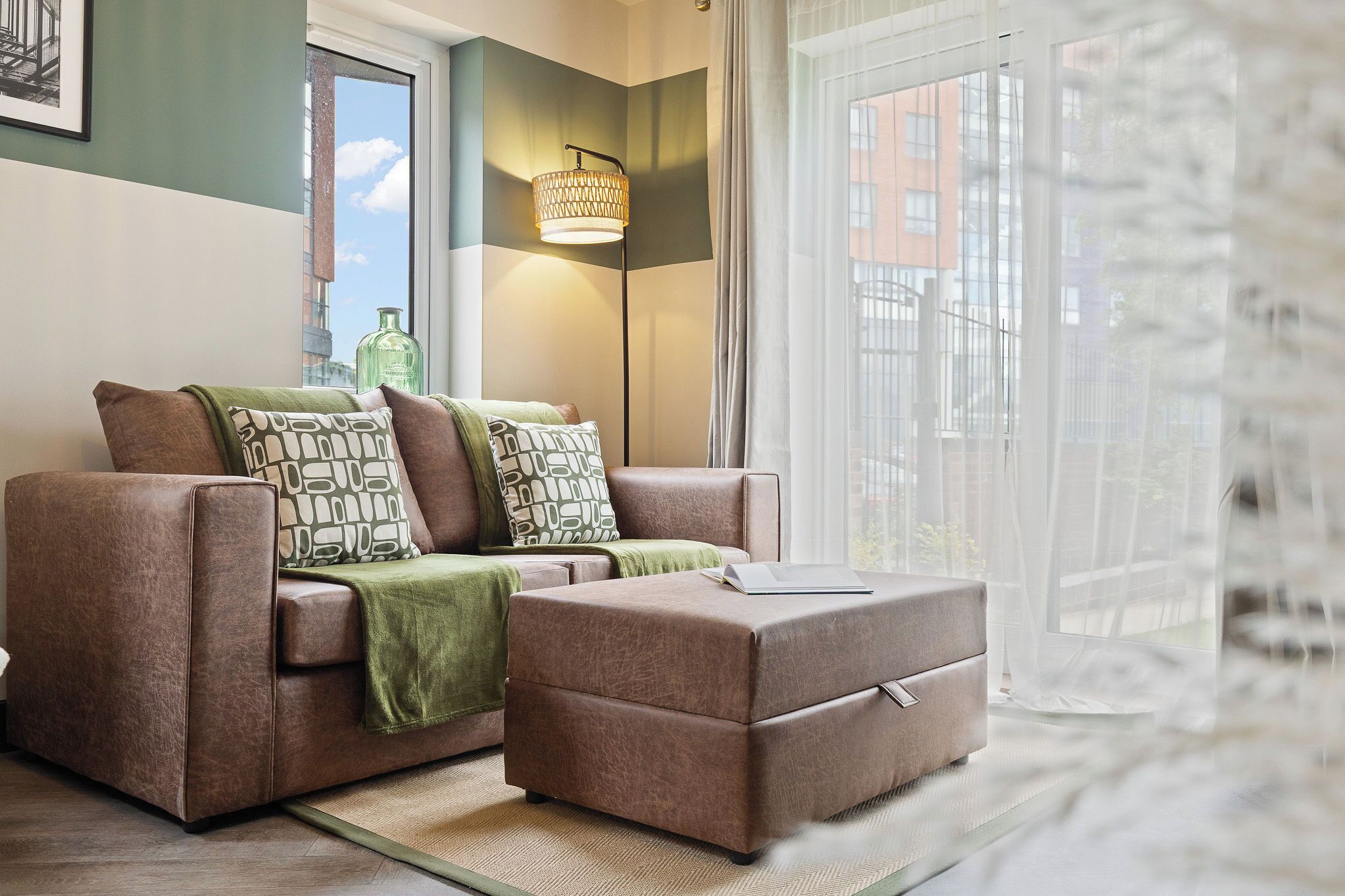 A modern living room with a sofa set, a coffee table, and a floor lamp.