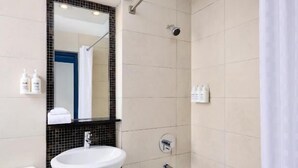 A bathroom with a white sink, a bathtub, and a shower. - Classic Yonge Stay (Toronto)