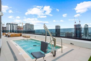 A rooftop pool with a city view, including high-rise buildings and construction cranes. - Luxury Miami 1BR Apt, Pool & Beach Access for 4 (Miami)
