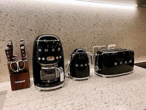 A kitchen counter with a coffee maker, toaster, and knife set. - Luxurious one bedroom flat in Central London, walking distance to Paddington (London)