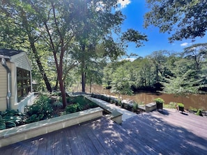 A wooden deck with a view of a river and dense foliage. - Boutique Riverside Retreat (Seaford)