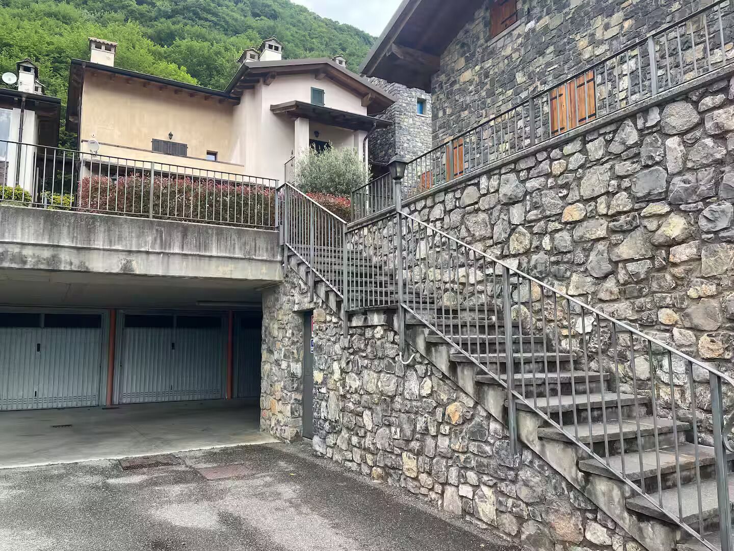 Una escalera de piedra que lleva a un edificio con garaje.