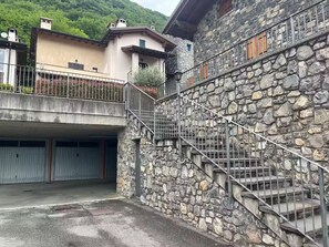 A stone staircase leading to a building with a garage.
