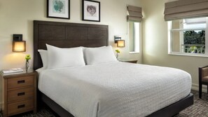 A neatly made bed with a headboard, bedside tables with lamps, and framed artwork on the wall. - Bonita Springs 1BR Villa at Coconut Cove Near Gulf Beaches & Naples (Bonita Springs)