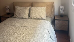 A bedroom with a bed, two nightstands, and a window. - 
Central 2-Bedroom Apartment in Barcelona. (Barcelona)