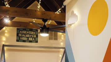 A bunk bed room with a sign that reads 'ADVENTURE IS ALWAYS A GOOD IDEA.'