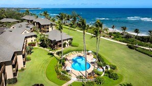 A resort with a swimming pool, beachfront view, and multiple buildings. - Breezy 4BR, 2 Condos for 12 at Kaha Lani, Lihue! (Lihue)