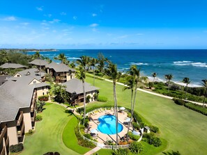 A resort with a swimming pool, beachfront view, and multiple buildings. - Breezy 4BR, 2 Condos for 12 at Kaha Lani, Lihue! (Lihue)