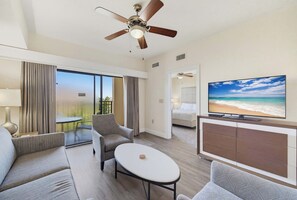 A hotel room with a balcony, a television, and a bed. - Floridays 505D: 2BR for 6, Heated Pools, Free Parking & No Resort Fees (Orlando)