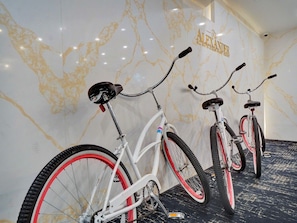 Three bicycles parked against a wall with a marble pattern. - Spacious 2BR Resort-Style Apartment with Ocean Views 504 (Miami Beach)
