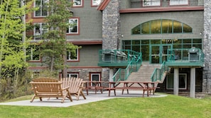 A building with a stone facade, multiple windows, and a green staircase leading to an upper level. - 2BR Suite at WorldMark Canmore-Banff Near Banff National Park & Skiing (Canmore)