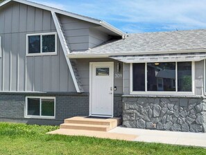 A modern two-story house with a stone foundation and a grey siding exterior. - ᨒStylish 4BR | Movie Lounge | 10 min to Ft Carsonᨒ (Colorado Springs)