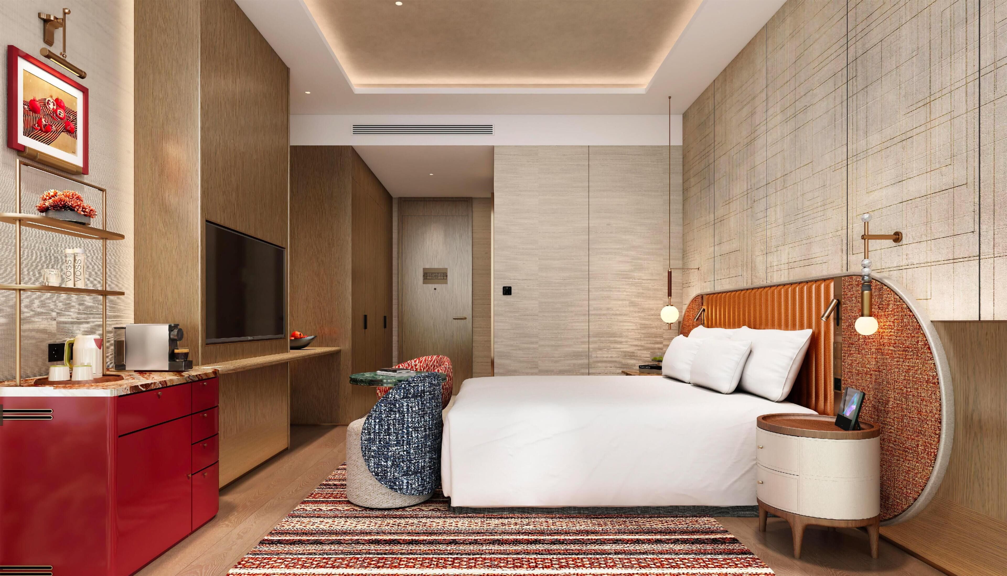 Un dormitorio moderno con una cama grande, un televisor, un aparador rojo y una alfombra estampada.