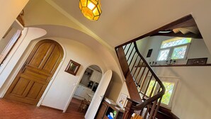 A staircase with a wooden handrail and a light fixture above it. - Cap d'Antibes, view of La Garoupe beach – Sleeps 8 – Garden and terrace (Antibes)