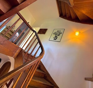 A wooden staircase with a handrail, a wall-mounted light fixture, and a framed artwork. - Cap d'Antibes, view of La Garoupe beach – Sleeps 8 – Garden and terrace (Antibes)
