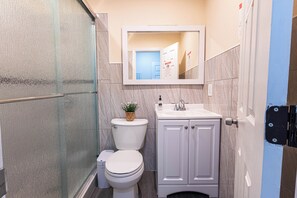 A bathroom with a toilet, sink, and shower area. - Private studio with its own entrance, minutes from MIA. Parking at the door (Virginia Gardens)