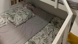 A bunk bed with a window and a door, a small table, and a wall-mounted shelf. - A cozy private space in Cuenca Batangas, perfect for relaxing getaways! (Cuenca)