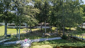 A residential area with a house, a swimming pool, and a grassy yard. - Lake it Easy Private Dock with fish cleaning station (Batesburg-Leesville)