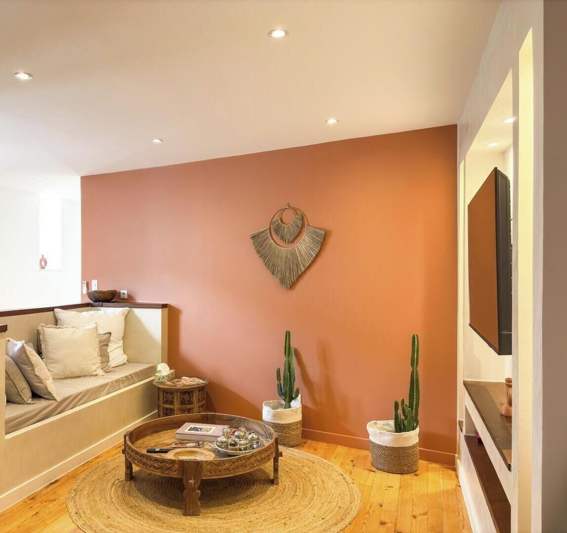 A living room with a sofa, coffee table, and decorative wall art.