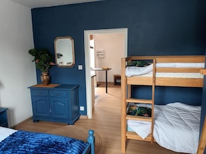 A room with a bunk bed, a dresser, a mirror, and a potted plant. - Gîtes de France® - French Overseas Departments and Territories (SAINT SOZY)