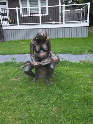 A sculpture of a seated figure in a park. - John Boxtel Retreat – A One-of-a-Kind (Greater Napanee)