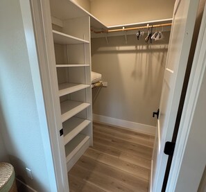 A walk-in closet with open shelves and a hanging rod. - New build cabin with AC on 20+ acres outside Custer (Custer)