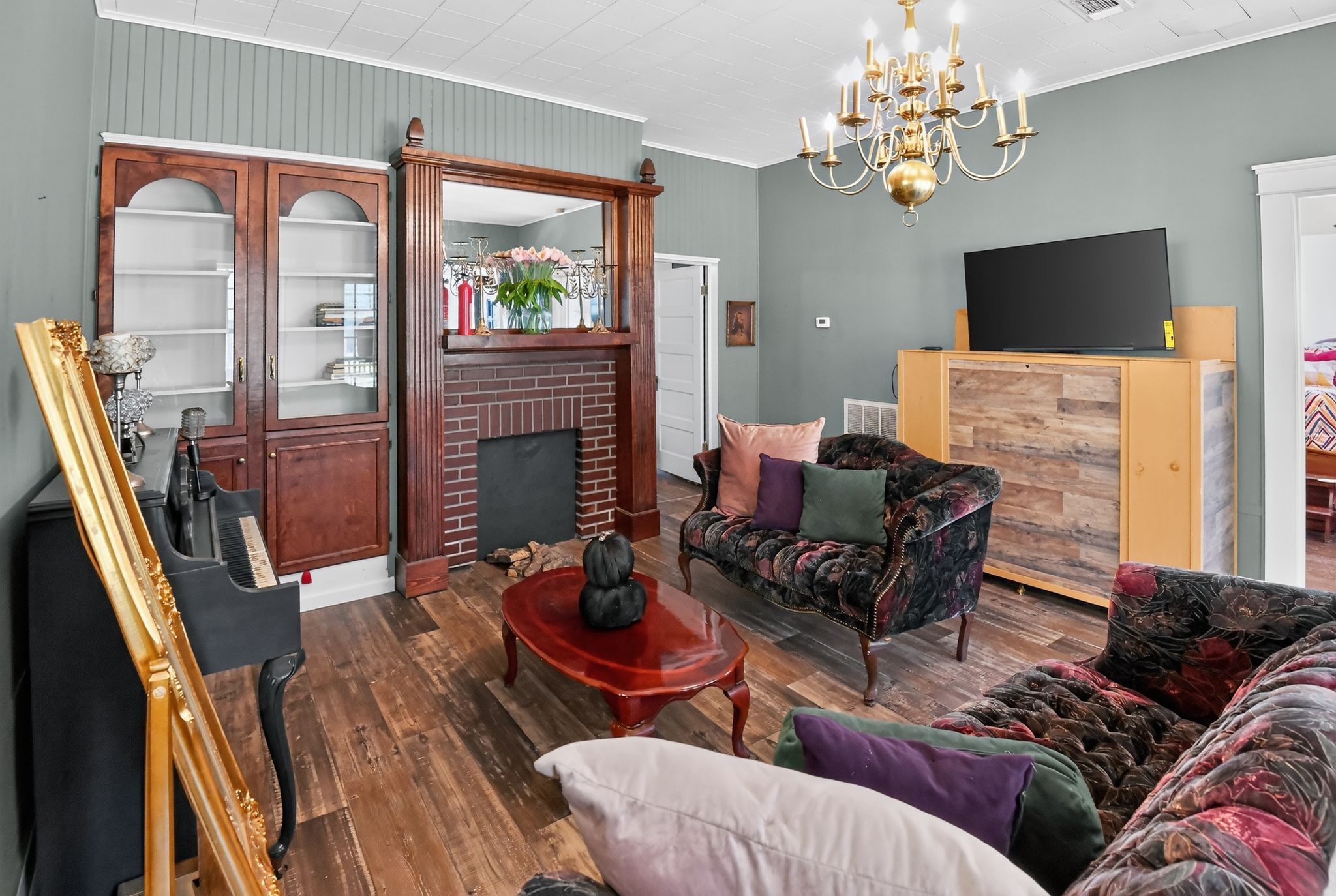 A living room with a fireplace, a television, and a sofa.