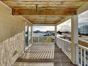 A covered balcony with a view of the cityscape. - 4BR in Downtown Surf City • 1 Block to Beach (Surf City)