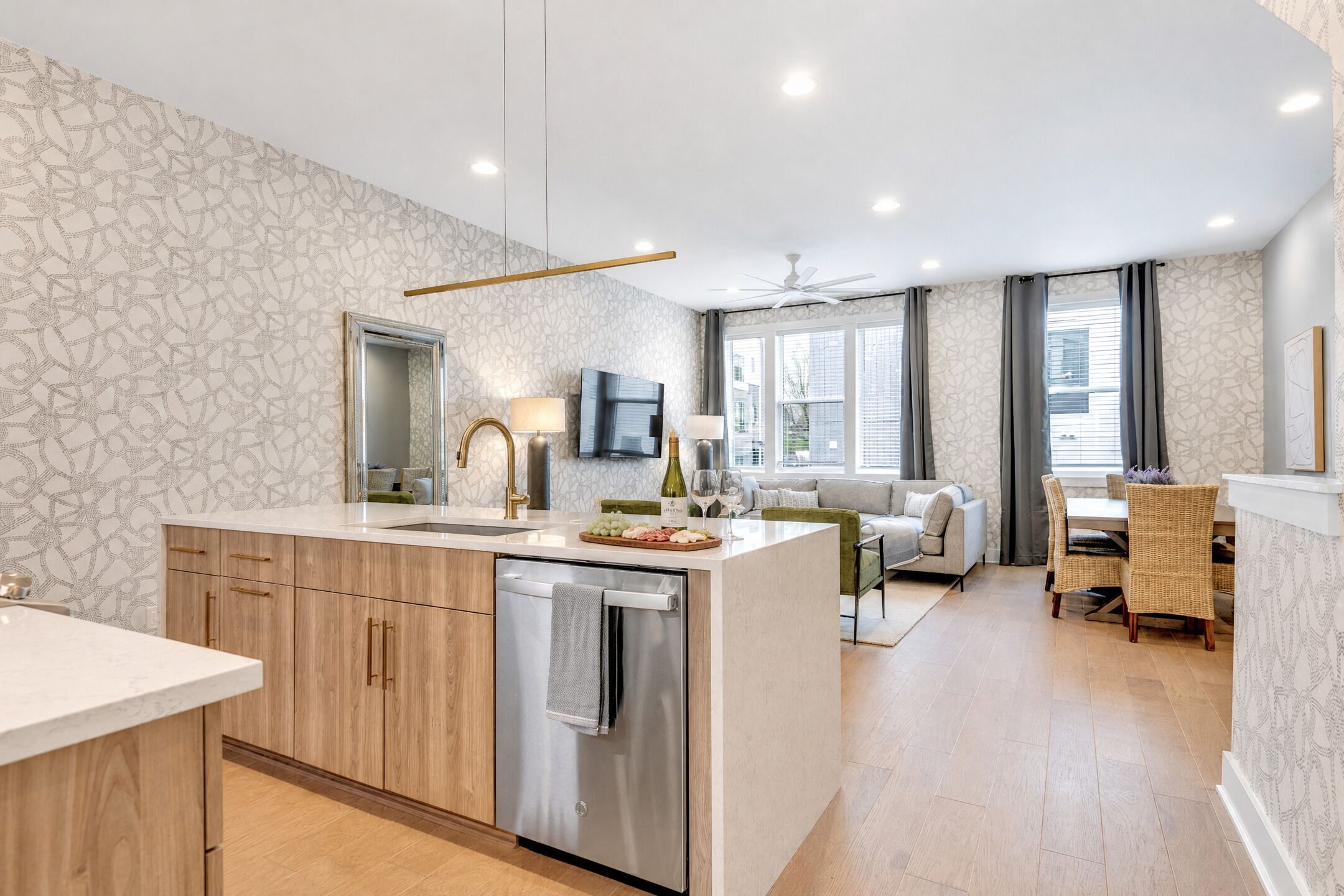 Kitchen island with a built-in dishwasher opens seamlessly into the living area, keeping the cook connected to the group while meals come together