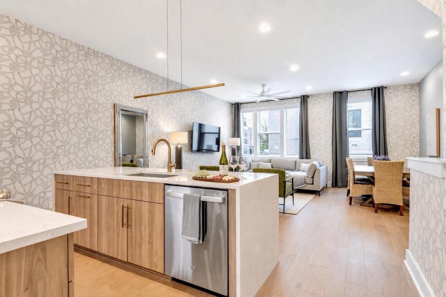 A modern kitchen with a central island, wooden cabinets, and a built-in dishwasher.