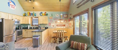 A cozy interior with a kitchen, dining area, and seating.