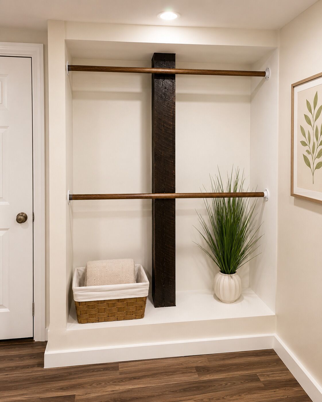 A room with a wooden floor, a white door, a shelf with a plant, and a basket.