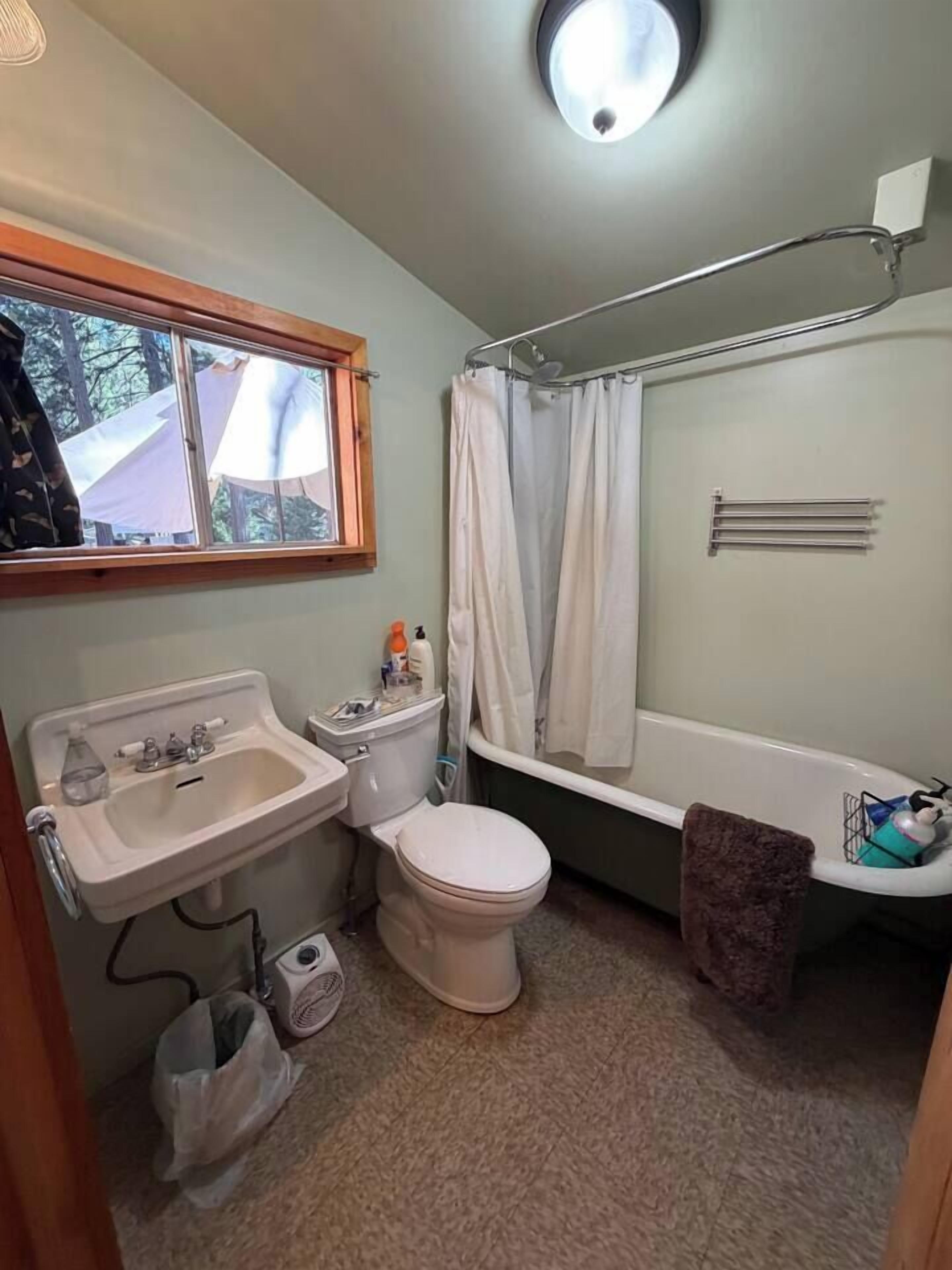 A compact bathroom with a sink, toilet, and bathtub.