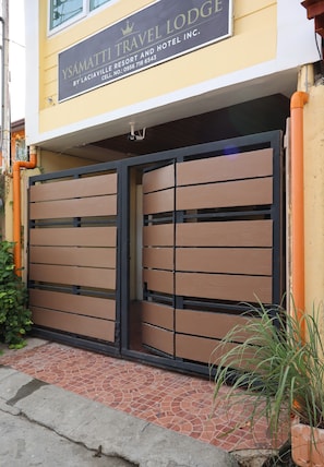 A gated entrance to a property with a sign indicating it is a travel lodge.