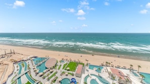 A resort with multiple swimming pools, a beach, and ocean views. - Verano 1601 – Spacious Corner Condo (Puerto Peñasco)