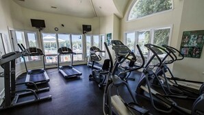 A gym with treadmills, a stationary bike, and a weight machine. - Out of Office OBX | Private Pool, Hot Tub, Dog Friendly, and Community Pool (Corolla)