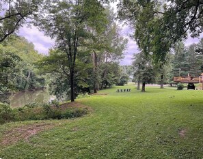 A park with a pond, trees, and a gazebo. - Tranquil Riverfront Retreat (Depauw)
