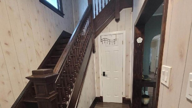 A wooden staircase with a handrail leading to a white door. - The Hideaway Walk to Falls W/D Sleeps 8 (Niagara Falls)