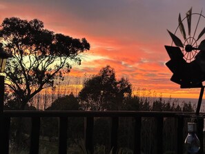 A sunset with a windmill in the foreground. - Bang for your buck, Sanctuary, Sea & Starry nights, 5 minutes from Gore Bay! (Domett)