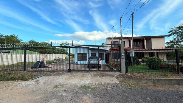 Une propriétéClose, avec un petit bâtiment, une voiture garée et un ciel dégagé.