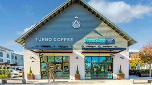A building with 'TURBO COFFEE' and 'Peccini's ICE CREAM CANDY KITCHEN' signs. - Dune Manor 124-Pool + Rooftop Deck-Sleeps 16 (Seagrove Beach)