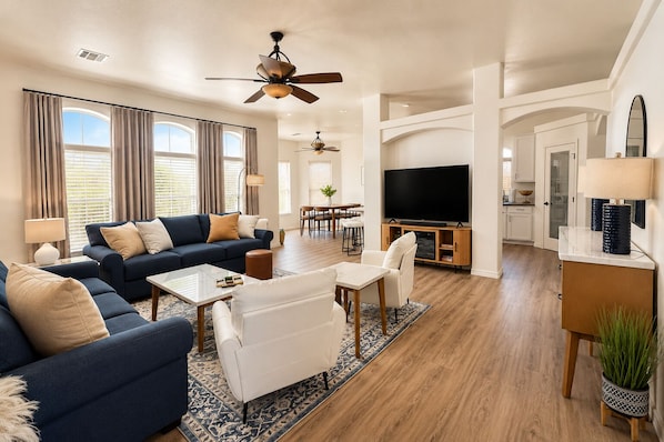 A modern living room with a sofa, coffee table, and TV.