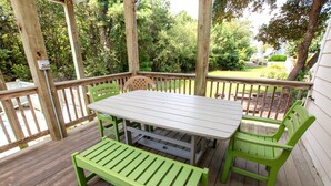 A wooden deck with a table and chairs, surrounded by a wooden railing. - Soundside- Golf Community, Priv Pool, Htub-MB3, How Sweet the Sound (Corolla)