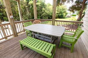 A wooden deck with a table and chairs, surrounded by a wooden railing. - Soundside- Golf Community, Priv Pool, Htub-MB3, How Sweet the Sound (Corolla)