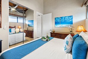 A hotel room with a bed, a dresser, a mirror, a window, and a painting. - Stunning West Maui Oceanview Retreat (Honokowai)