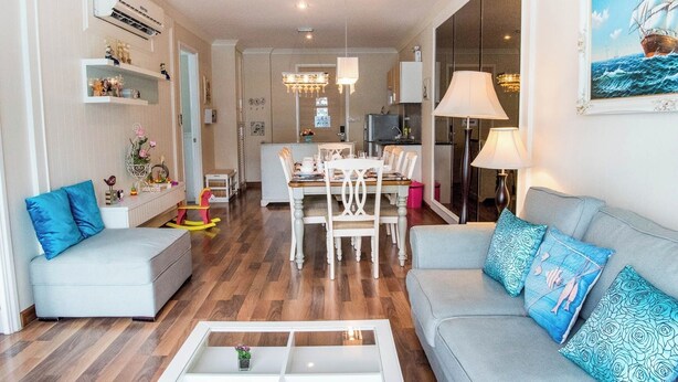A modern living room with a sofa, a coffee table, and a dining area with chairs and a table. - D606 Bright 2-bedroom apartment with Playground near Sea, city (Huahin)