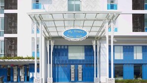 A hotel entrance with a blue and white facade, a covered entrance area, and a sign that reads 'My Resort Hua-Hin.' - D606 Bright 2-bedroom apartment with Playground near Sea, city (Huahin)