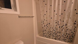 A bathroom with a toilet, a bathtub, and a shower curtain. - Gamma
A beautiful master bedroom with bathroom in a town house. (Fort McMurray)