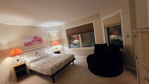 A bedroom with a bed, bedside lamps, a chair, and a wardrobe. - Gamma
A beautiful master bedroom with bathroom in a town house. (Fort McMurray)